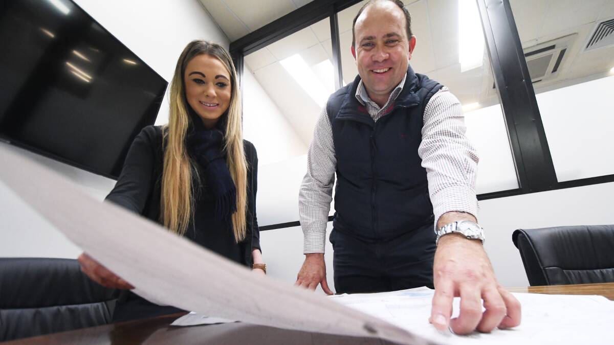 HIGH TECH: Burke and Smyth commercial property assistant Jessica Caslick and principal Gavin Knee with concept plans. Photo: Gareth Gardner 160519GGB01