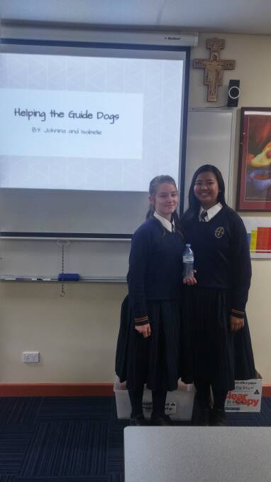 BOTTLE DONATION: McCarthy Catholic College students Isabelle Neville and Johnina Facistol present their Guide Dog fundraiser using Return and Earn bottles project. 