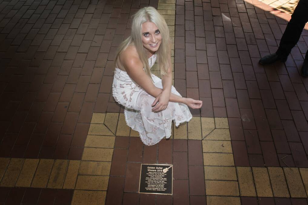 CHUFFED: Tamworth country music artist Aleyce Simmonds with her Winners Walkway plaque on Peel Street. Photo: Peter Hardin