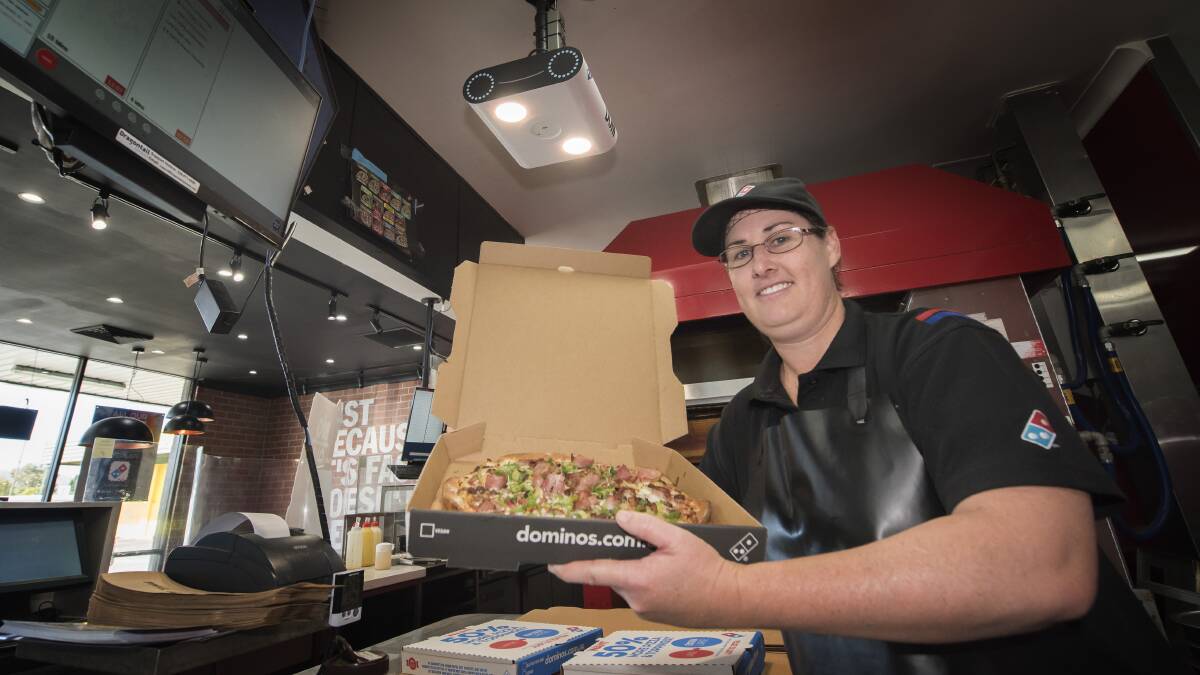 A SERVE OF SCI-FI: West Tamworth Dominos staff member Naz McGregor with the new AI camera that will check the pizzas. Photo: Peter Hardin 280519PHB012