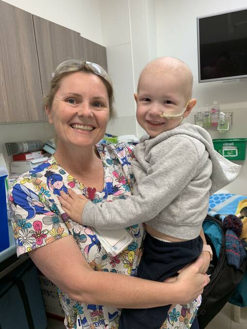 RECOVERY: Leo (right) with one of the nurses at John Hunter Hospital during treatment.