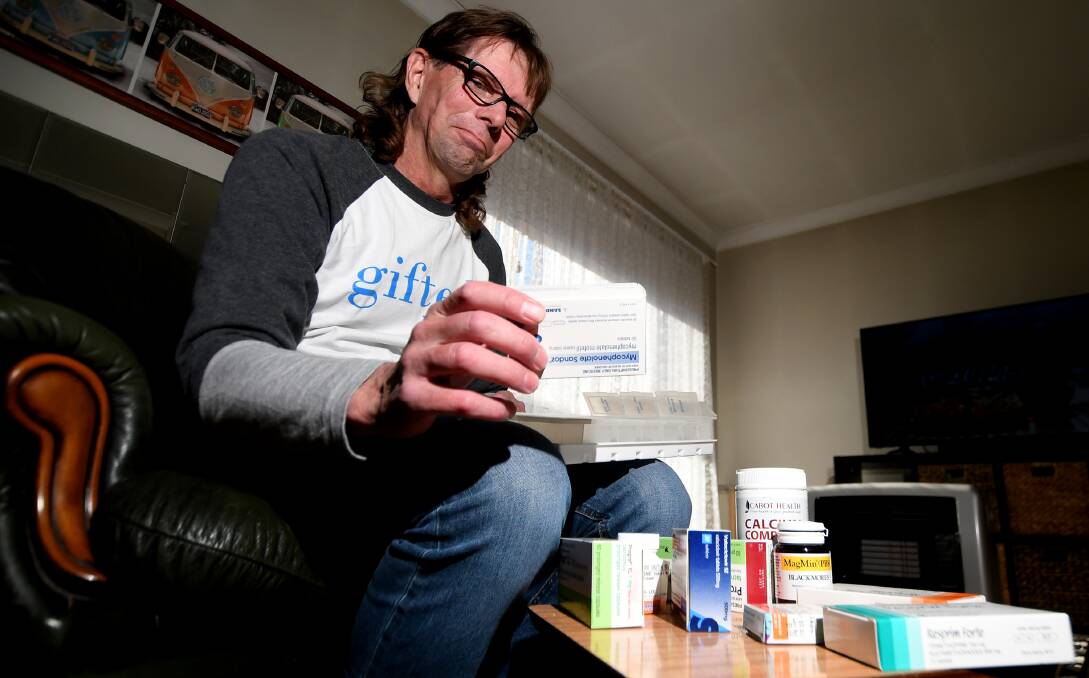 GIFTED LIFE: Tamworth's Craig Lee with the myriad of pills he has to take to stop his lungs from rejecting. Photo: Gareth Gardner 250619GGA03