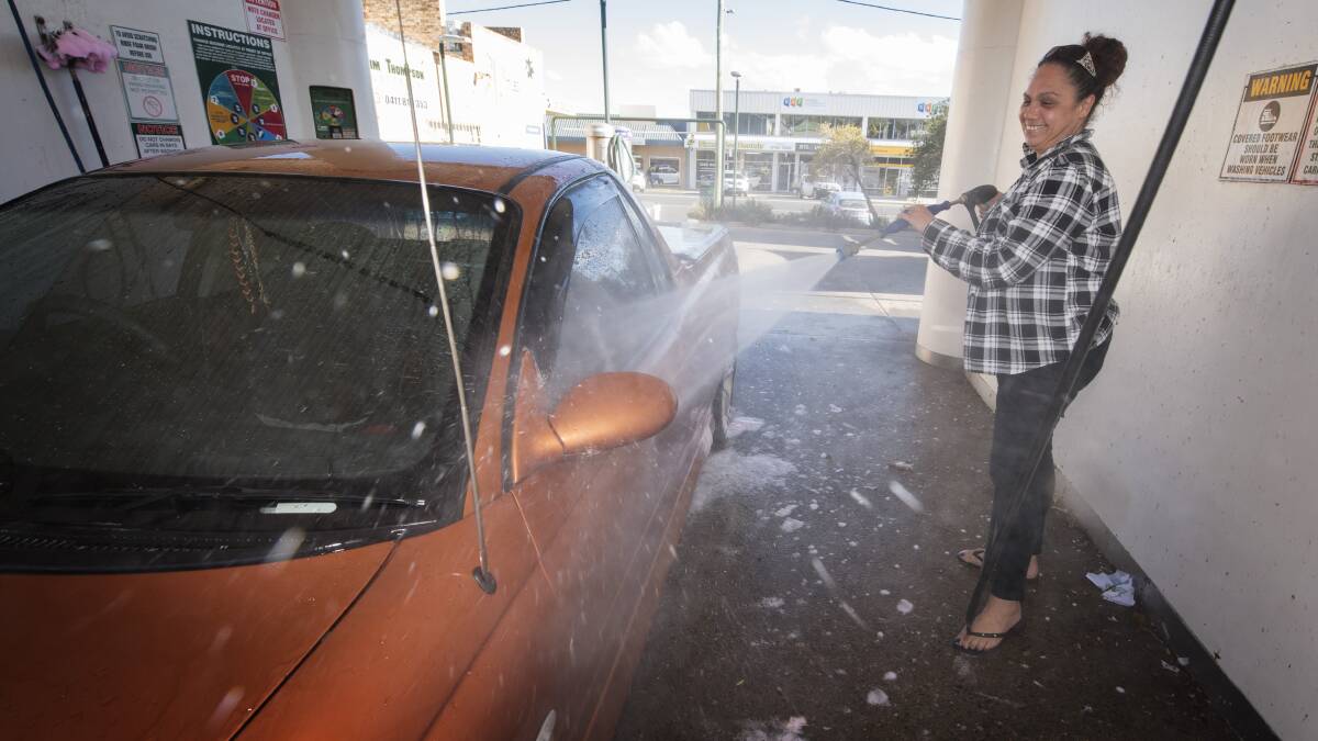 CLEANED UP: Rebecca Krisanski gives her car a good clean at Clover Carwash on Monday. Photo: Peter Hardin 270519PHF008