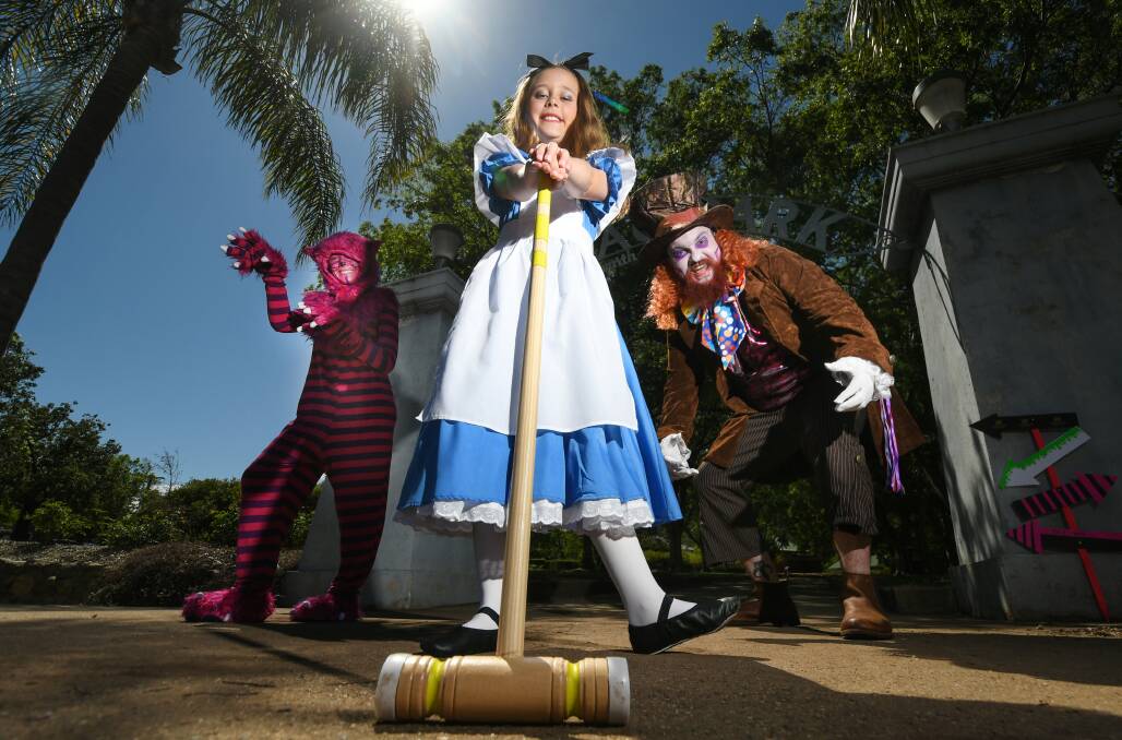 WONDERLAND: Georgina Maio as Alice, Tara Withers as the Cheshire Cat and Aaron Jones as the Mad Hatter. Photo: Gareth Gardner 061020GGA02