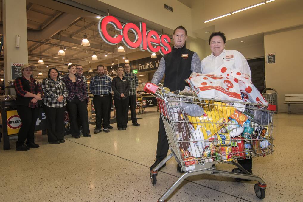 DOING IT FOR FARMERS: South Tamworth Coles manager Brock Mackay and 2IC Tanya LeGarde with donations for drought-affected farmers. Photo: Peter Hardin