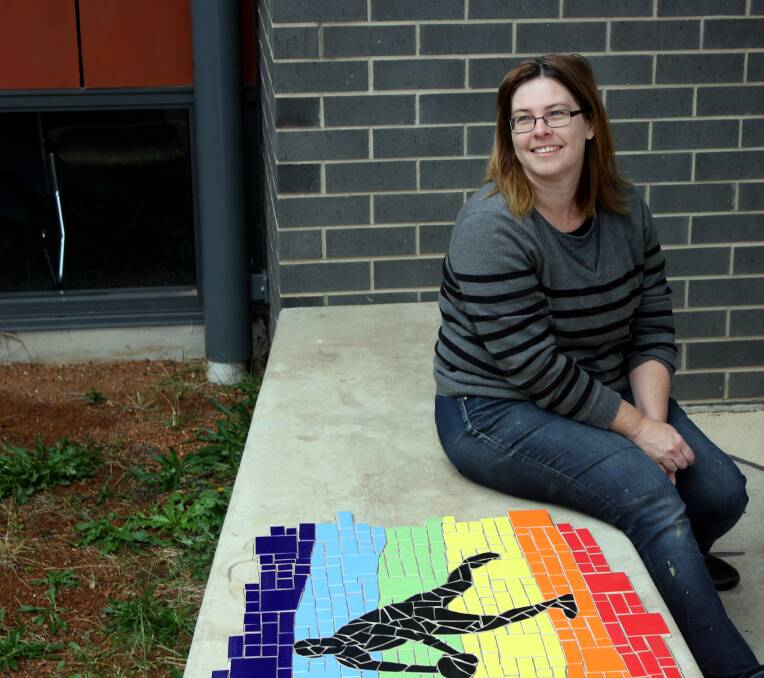 FLAIR: Tamworth Regional Art Collective artist Joanne Stead with her section of the new mural, inspired by activities and Aboriginal culture. Photo: Madeline Link