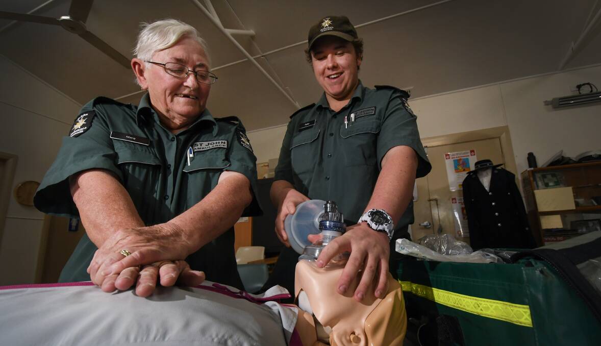 HEROES IN GREEN: Tamworth St John Ambulance superintendent Margaret O'Connor and member Dylan Johnston practice CPR on a dummy. Photo: Gareth Gardner