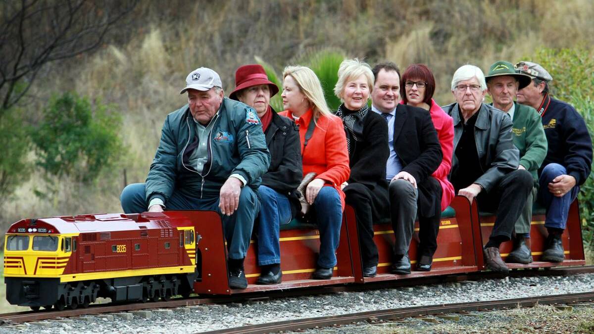 ALL ABOARD: The Singh family and model train fans at the Oxley Loop opening. From left, Gordon and Jill Laidlaw, Janelle Singh, Gwen Singh, Bryan and Helen Singh, Warren Woodley, David Scott and Brian Carter.