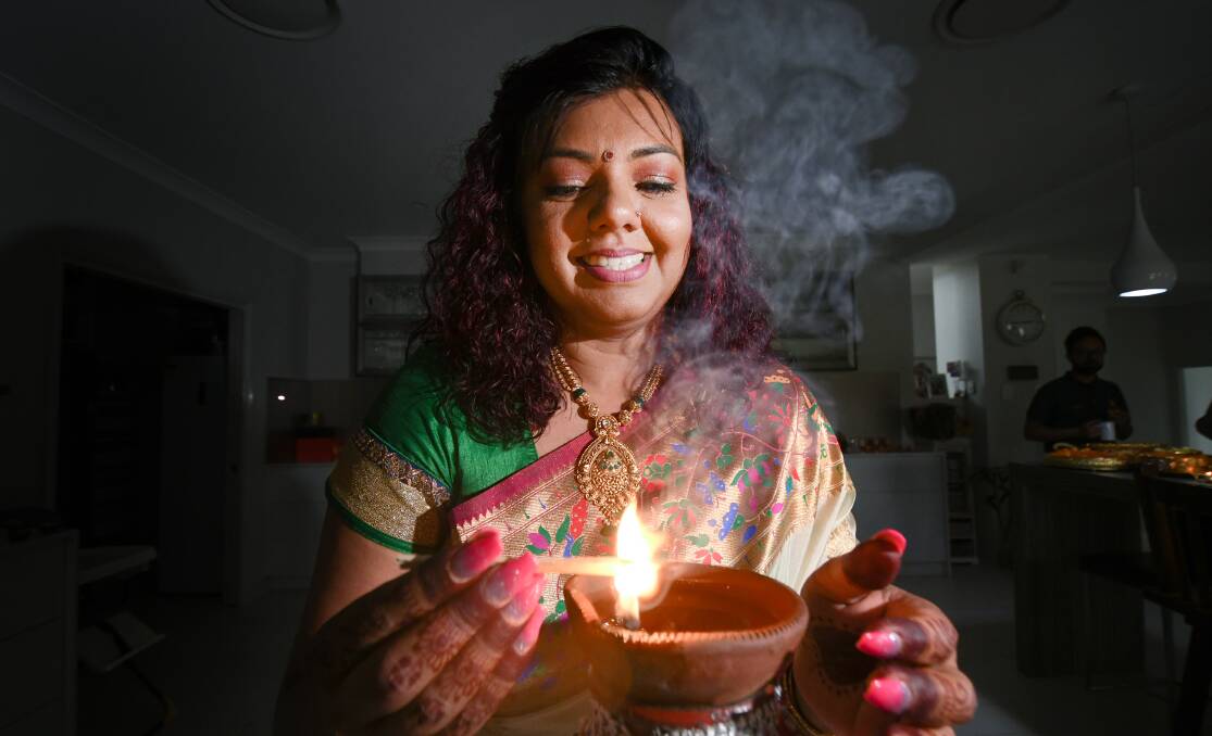CULTURE SHINES: Fiji-Indian Shalini Pratap lights the earth candle for Diwali. Photo: Gareth Gardner 