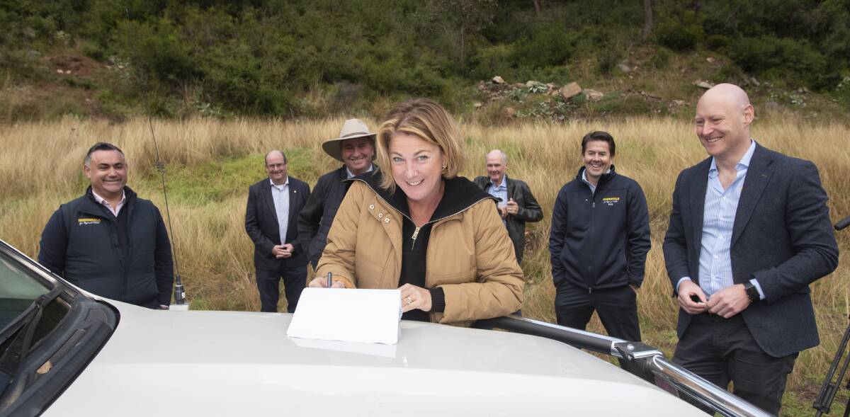 SHORED UP: Water Minister Melinda Pavey signs the contract for the new Dungowan Dam in May. Photo: Peter Hardin 250520PHA206