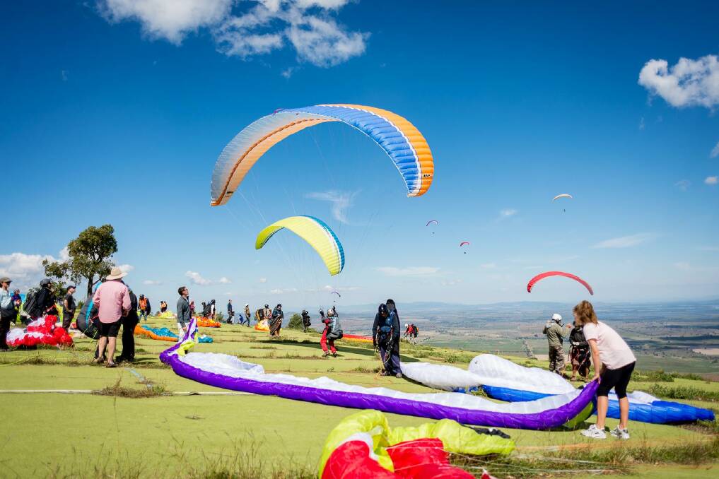 Get higher and higher: Paragliders take off from Mt Borah during the annual State of Origin event staged in Manilla across three days of the Easter period.