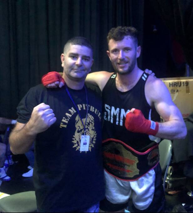 Achiever: Sapphire Academy of Sport manager Darren Finn and knockout performer Rob Murray after Saturday's fight at BoxingMania 8. Photo: Supplied.