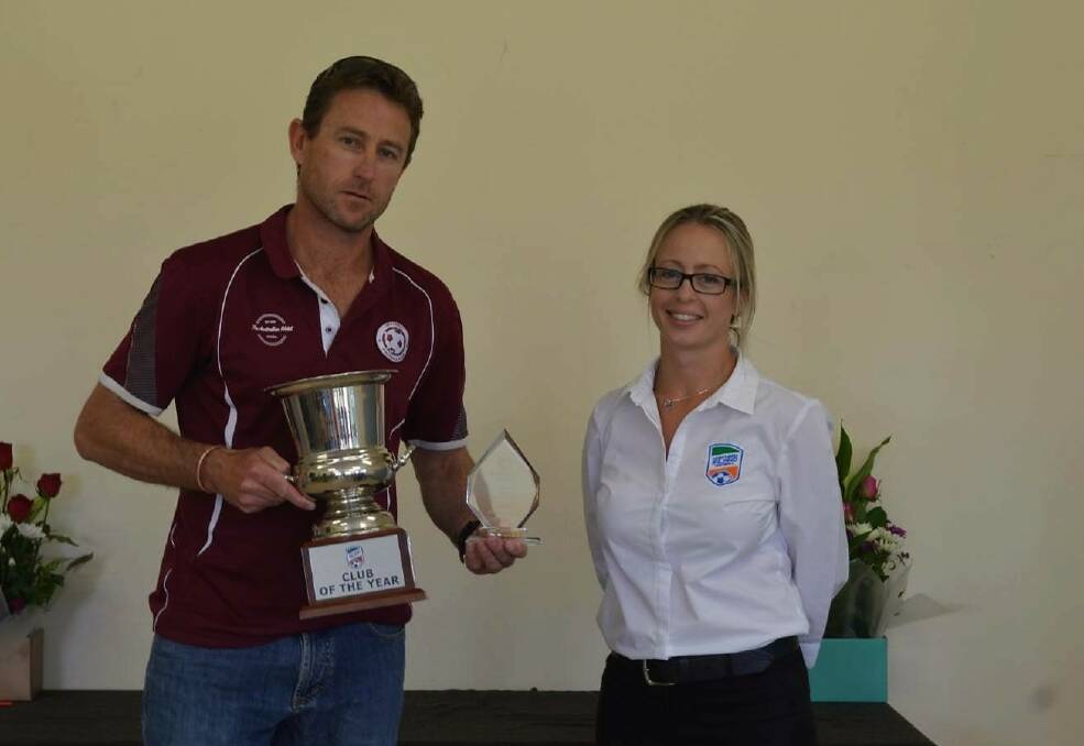 Kicking goals: Inverell FC president Anthony Alliston accepts the club of the year award from NIF Northern Inland Football general manager Julia Farina. Photo: Supplied