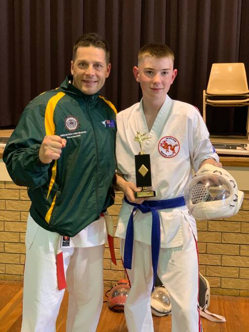 Talent on the rise: Sensei Nick King with William Cripps holding his age division first place trophy and the broken helmet.