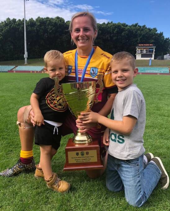 Family pride: Jess O'Brien holds the NSW Police City vs Country trophy with her sons, Darcy (left) and Jedd. Photo: Supplied.