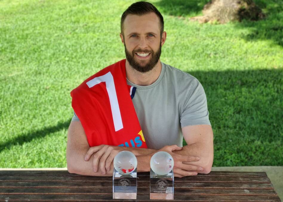 James Goddard shows off his parents' life membership trophies and the club jersey presented to him by OVA which bears his father's playing number. Picture by Zac Lowe.