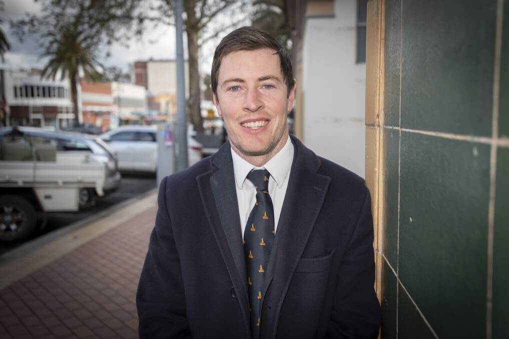 During the day: When Richie O'Halloran isn't playing for the Roos, he is a lawyer with RJ O'Halloran and Co, which his ancestor opened over a century ago. Photo: Peter Hardin.
