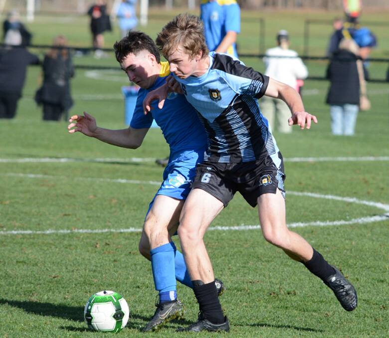 Fight for it: Oxley's Jonah Thompson (right) jockeys for possession during a game last week in Bathurst. Photo: NSW Combined High Schools Football. 