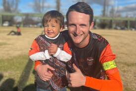 Mitch Harding with his youngest son, Samuel, during the 2023 season. Picture supplied.
