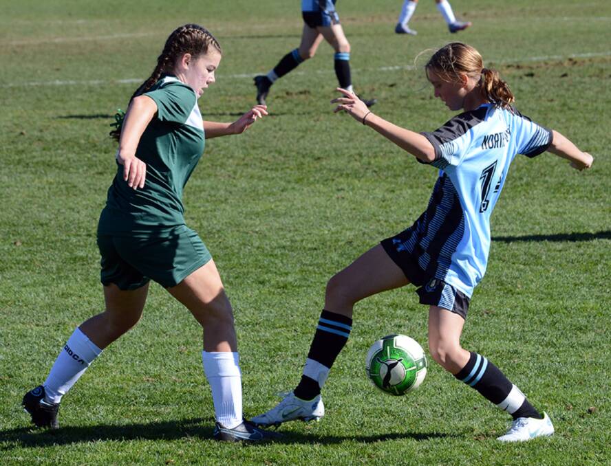 Fancy footwork: Oxley High School's Pip Mattheus (right) evades her opponent during last week's NSWCHS State Championships in Bathurst. Photo: NSW Combined High Schools Football.