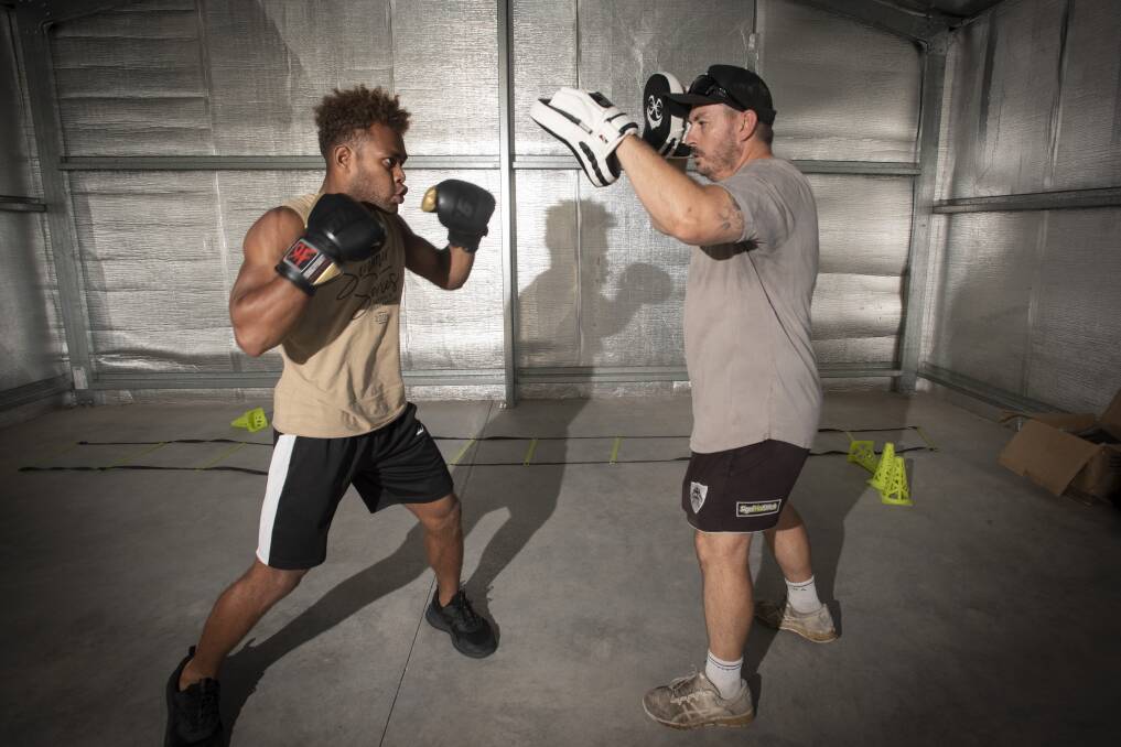 Hard work: Silisia trains twice most days, and his coach, Jamie Carroll (right) believes they can win the junior middleweight amateur title this Saturday. Photo: Peter Hardin.