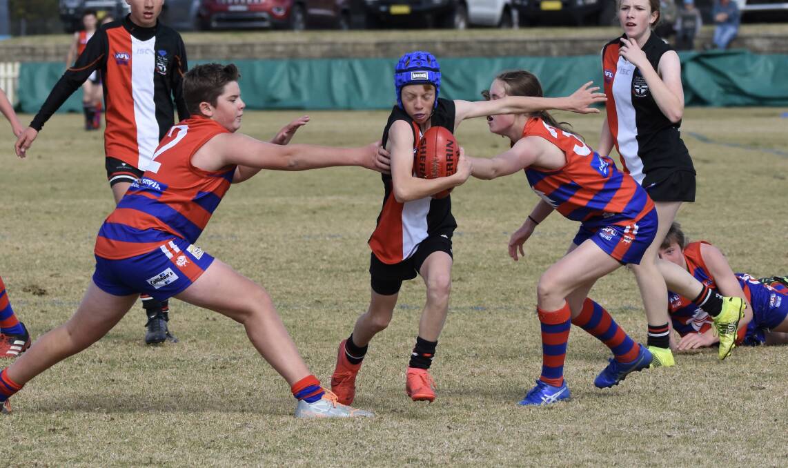 The Tamworth Roosters couldn't stop Inverell's young guns from running away to a 13-point win in the AFL North West under 14s grand final. Picture AFL North West.