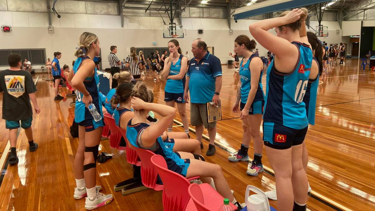 The Thunderbolts women listen to coach Dave McCubbin during a game in Port Macquarie over the weekend, where they produced superb basketball. Picture by Tamworth Thunderbolts.