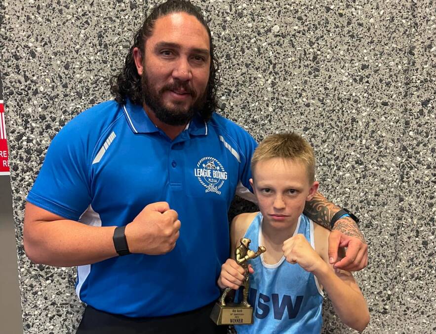 Reid Gray is all business after his win alongside One2Boxing and NSW under 14s coach, Anthony Rogers. Picture by One2Boxing Westside. 