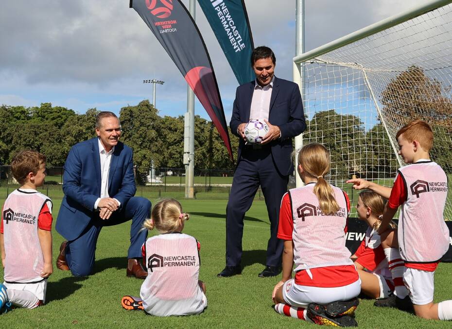 Kick along: Northern NSW Football CEO David Eland, Newcastle Permanent Chief Customer Experience Officer Paul Juergens and young players from Merewether United Football Club. The financial institution will continue in it's role as NNSWF's major partner of community football