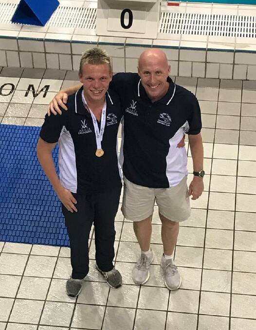 Connor Roberts with coach Nicolas Monet after winning the 200 individual medley.
