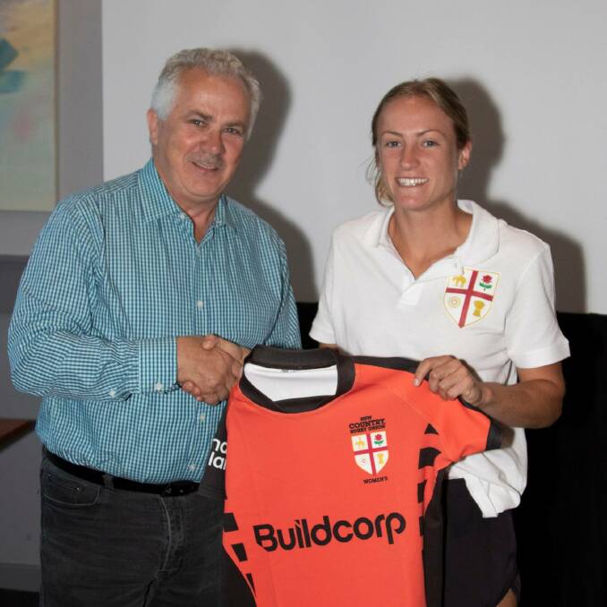 Claudia Nielsen receives her jersey from NSW Country stalwart Terry Woodward. 