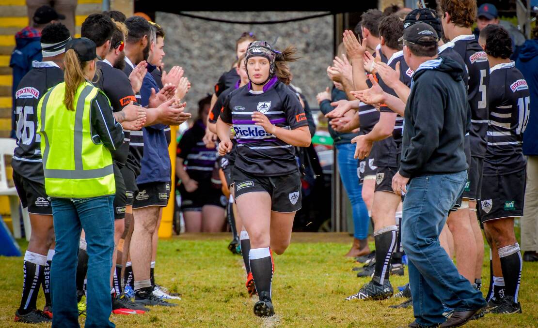 Huge honour: Lucy leads the Magpies out. Photo: Bugsy Plowman Photography
