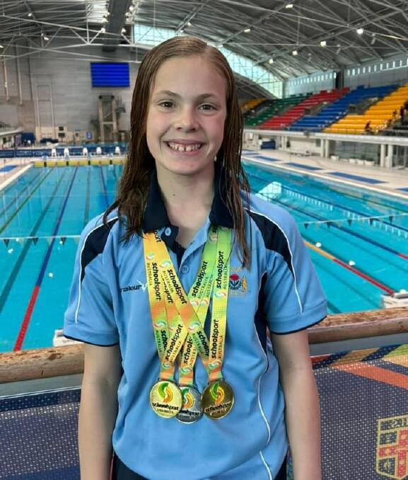 Molly Ramien with her medal haul from the School Sport Australia Swimming Championships. Picture Armidale Diocesan Primary Sport Council Facebook