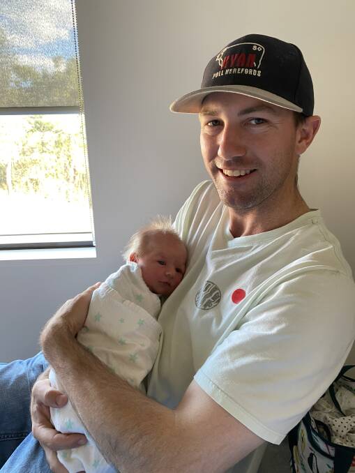 Life-changing: Luke Smith proudly holds new daughter Evelyn Grace.