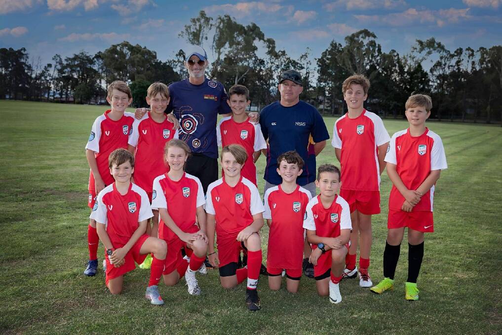 Meeting royalty: NIAS' under-12 Inverell football squad pictured with former Socceroo Craig Foster.