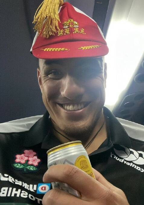 Prized possession: The smile says it all as Gunter shows off his Japan cap. Photo: Supplied