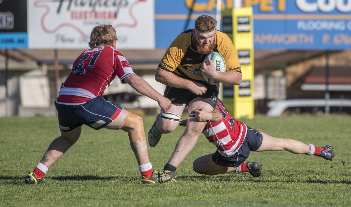 On the burst: Pirates second rower Nic McCrohan takes on two Walcha defenders during Saturday's epic grand final, which Pirates won by a point to claim back to back premierships. Photo: Peter Hardin