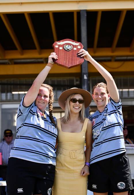 Gale (right) and co-captain Peta Cox hold aloft the women's silverware for the first time in Narrabri's history. They are with Santos representative Abby McClure. Picture by Gareth Gardner
