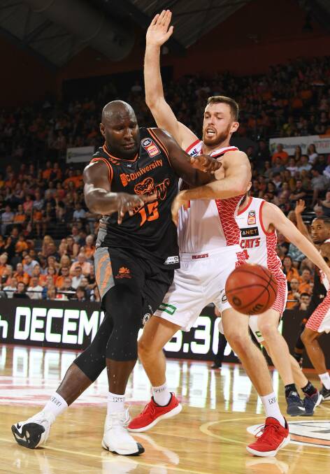 Tamworth's Nick Kay battles with Cairns' Nathan Jawai during the Wildcats' overtime win on Saturday night. Photo: Brian Cassey AAP