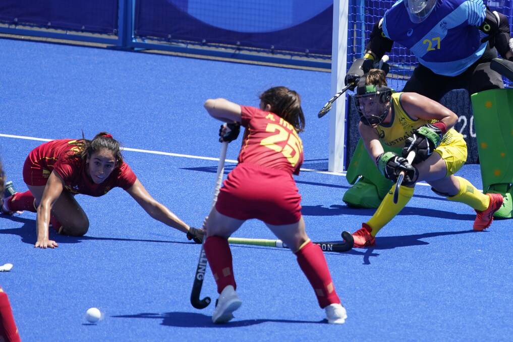 Last line of defence: Kate Jenner clears this ball from danger late in the first half of the Hockeyroos' campaign opening clash with Spain. Photo: John Locher; 