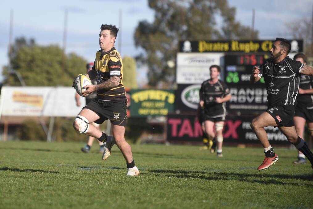 Pirates half-back Jackson Sharpe breaks out this counter-attacking raid through the second half, as Moree five-eighth Jamie Sampson gives chase.