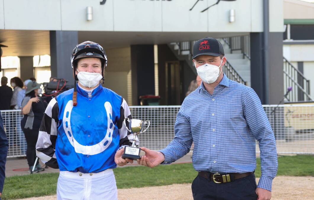 Eye-catching: Jockey Koby Jennings and trainer Cody Morgan with the Spring Cup after Edit's impressive win at Tamworth on Monday. Photo: Bradley Photographers
