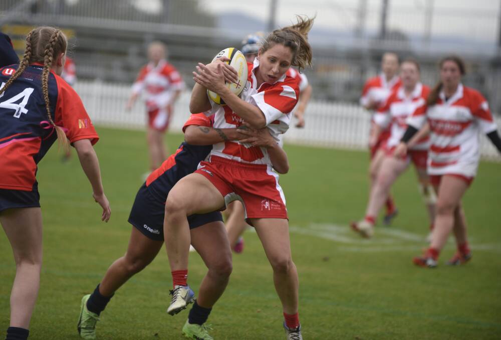 Crunch: Central North half-back Sarah Stewart is wrapped up by the Illawarra defence.