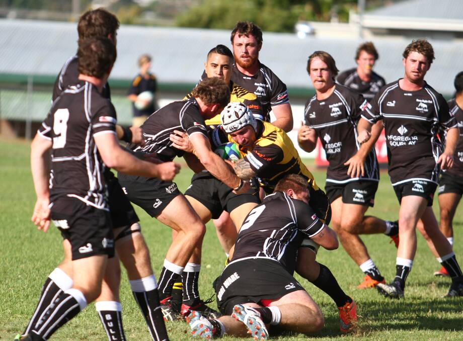 Tough: Pirates' Jack Shelton is wrapped up by the Moree defence during their first round encounter. The Bulls won the return clash 43-38 on Saturday. Photo: Mark Bode