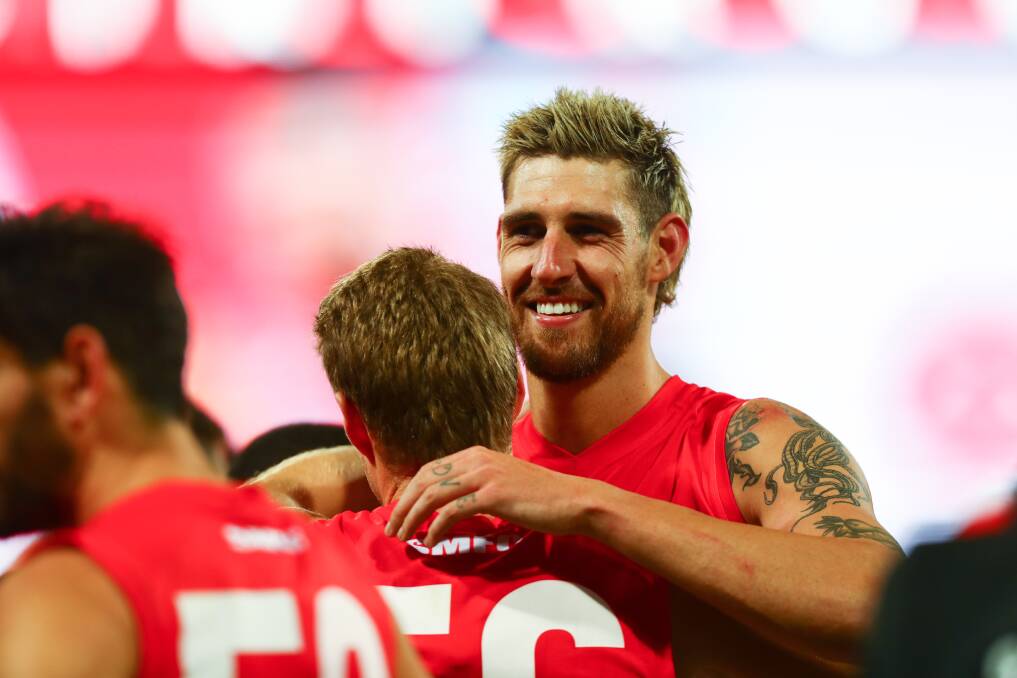 All smiles: Sam Naismith celebrates with a Swans team-mate after making his long-awaited return from injury on Saturday. Photo: Sydney Swans