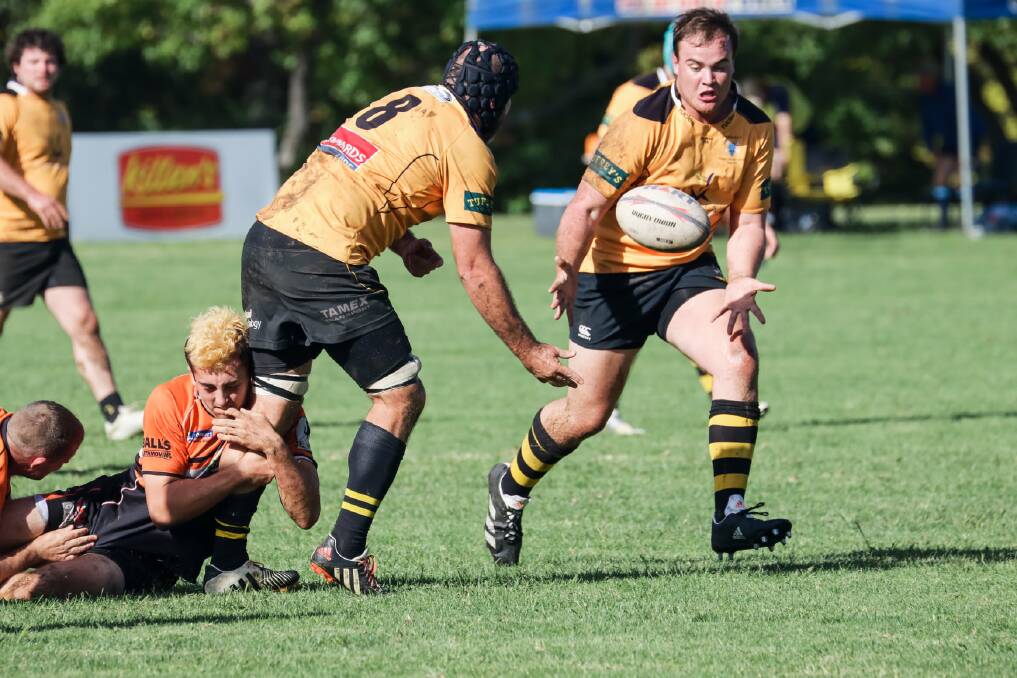 Out of my way: Pirates prop Michael Purtle bursts onto this offload from skipper Conrad Starr. Their 'second phase' play was one of the improved facets of their game in Saturday's Armidale Knockout. Photo: Catherine Stephen Photography.
