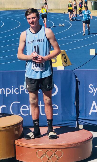 Podium effort: Glen Innes' Evan Byrne receives his bronze medal after finishing third in the 17 years boys long jump. Photo: Supplied