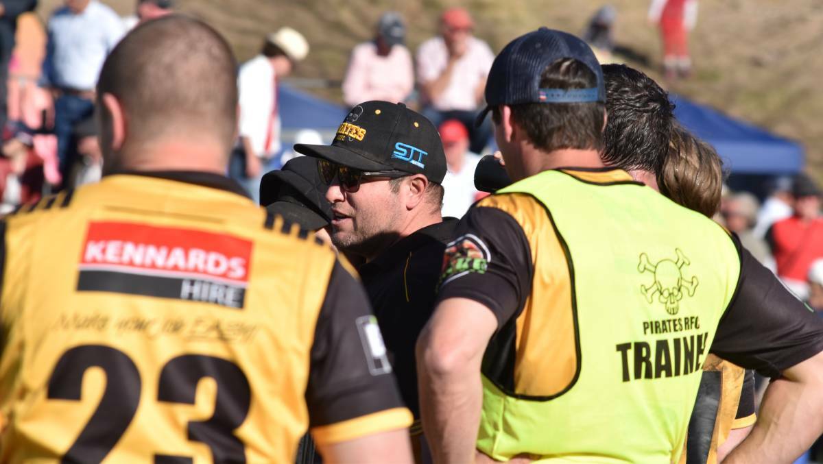 Words of wisdom: Pirates coach Mat Kelly addresses his charges at half-time. Photo: Ben Jaffrey