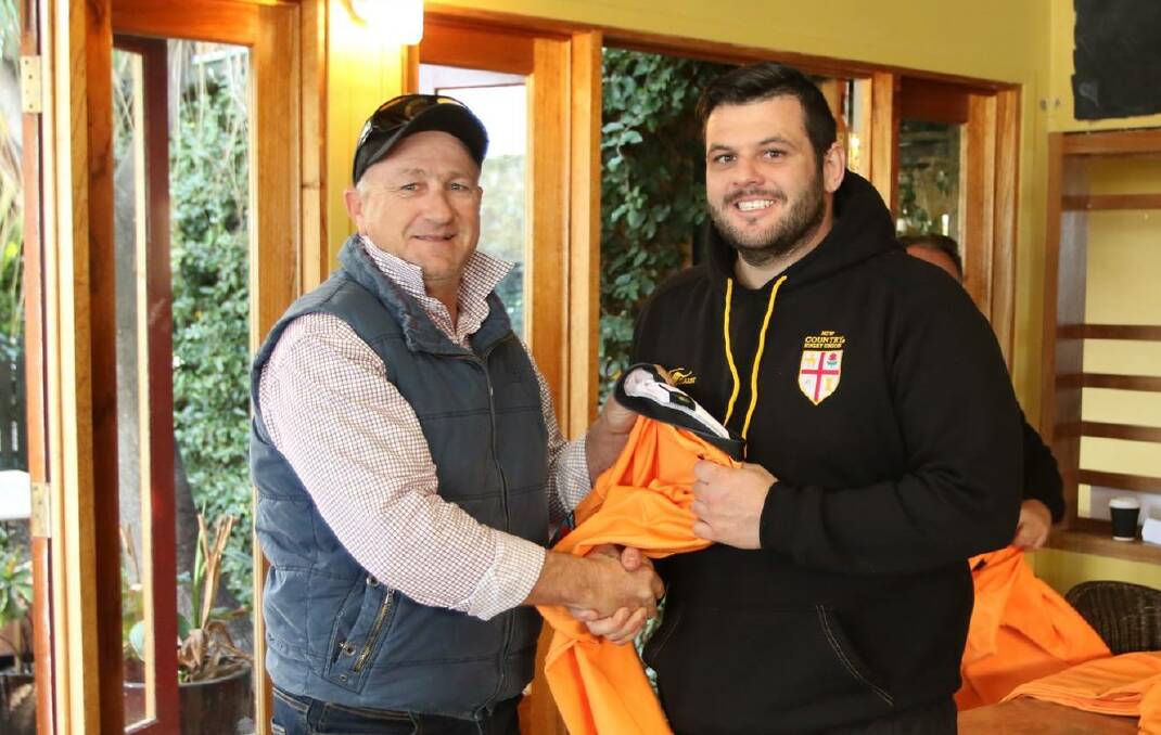 Former Wallaby and NSW Country Cockatoo Steve Merrick presents Andrew Collins with his jersey before Saturday's game.