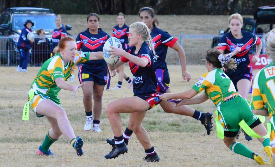 Evasive: Kootingal captain-coach Abby Schmiedel tries to thread the needle between Boggabri's Molly Dawson and Cailtyn Dewar on her way to four tries and a big win. Photo: Sue Haire.